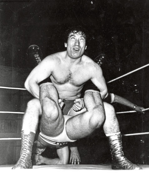 1986: Showing maximum effort, then councillor Len Ironside strives for the winning submission with a Boston crab hold