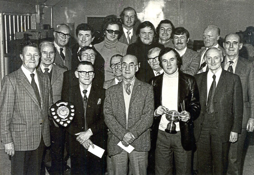 1970s: The AGM of the angling club in the early seventies with George KIng holding the cup