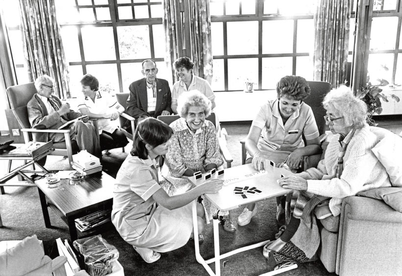 1990: Auxiliary nurses Sandra Anderson and Sue Harris play dominoes with Bella Stewart and Marion Vick