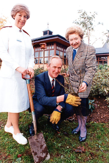 1990: Anne Cocker, right, of Cockers Roses, plants one of 50 roses donated by the firm to Roxburghe House