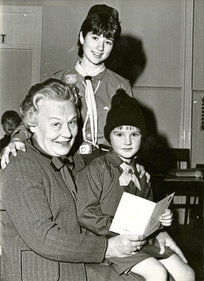 1985: Peggy Saxon, a founder Guide of the 1st Dyce Girl Guides, with Brownie Suzanne Clark and Guide Nicola McWilliam to celebrate the 1st Dyce Brownie Pack’s 50th anniversary
