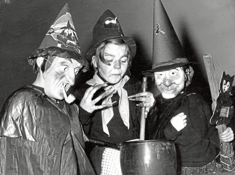 1960: Three Beechgrove Brownies put on a spooky display dressed as witches for their Halloween party