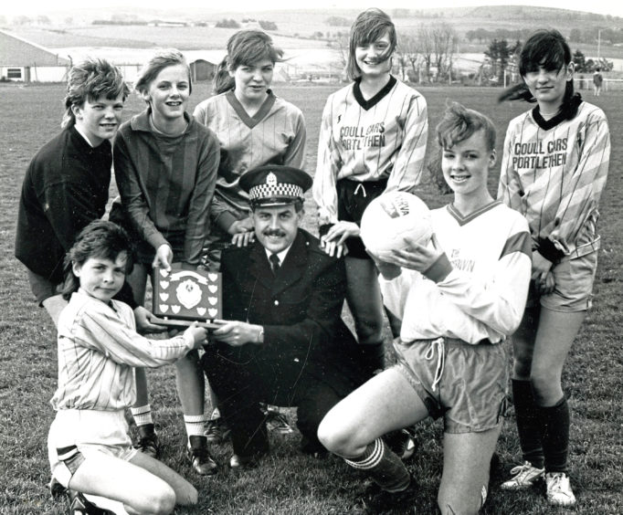 1989: Constable Gordon Ritchie, of the community involvement department, with players from the School Girls’ Tournament at Inverurie