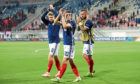 Scotland's Stuart Armstrong, Ryan Christie and Steven Fletcher applaud the fans after the final whistle.
