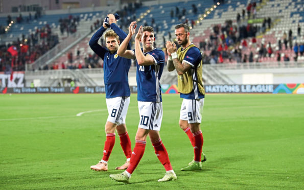 Scotland's Stuart Armstrong, Ryan Christie and Steven Fletcher applaud the fans after the final whistle.