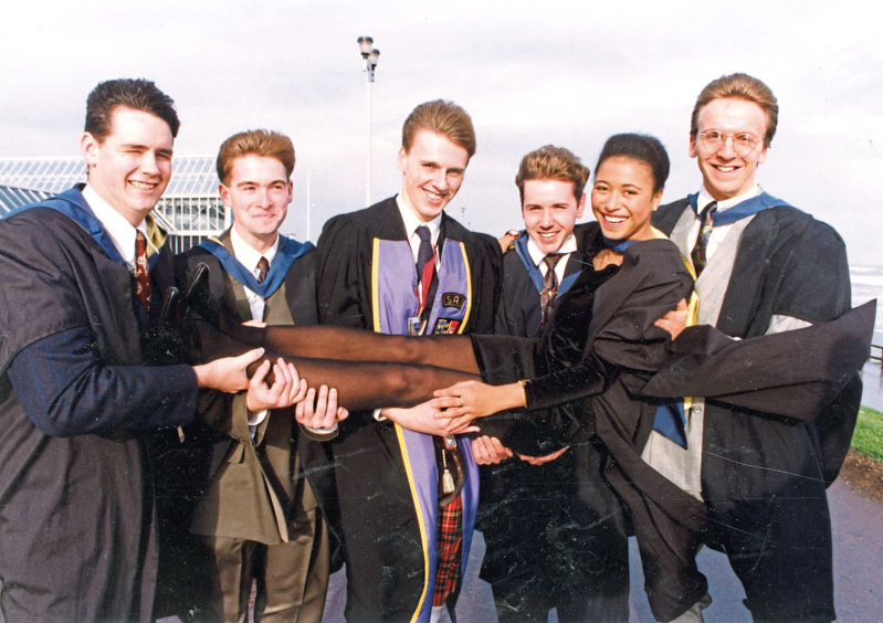 1991: Building surveying graduate Angelique Omotosho gets a lift from her classmates, from left, Gary Black, Chris Martin, Terry Wiggins, Gregor Stewart, and Tim Dale