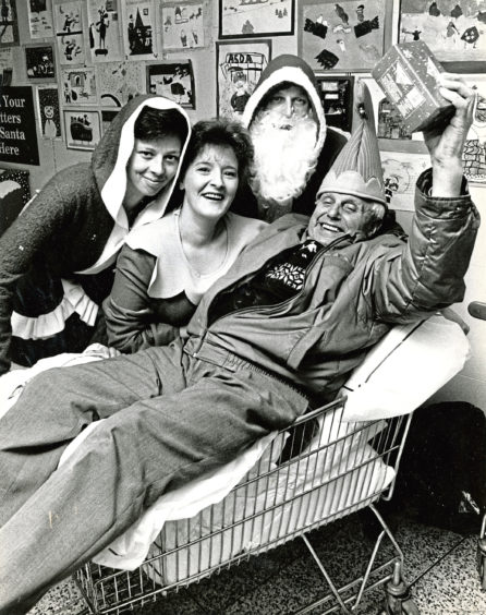 1989: Geordie Will, 84, gets a helping hand to get his shopping finished from Asda staff, from left, Karen Strachan, Alison Taylor and Eddie Murray at a special shopping event for senior citizens and disabled folk