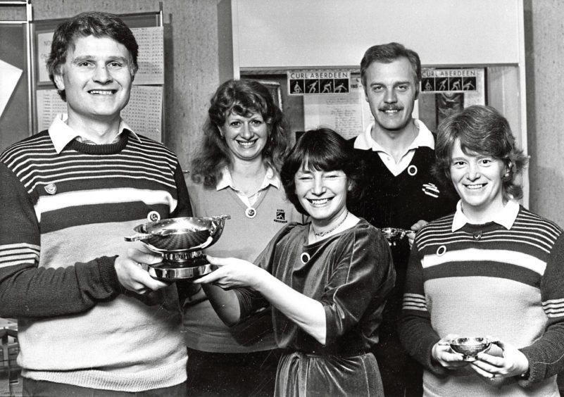 1985: George Rogerson, skip of the winning team in the Banchory Curling Club centenary bonspiel at Stoneywood, receives the trophy from Christine Paterson, the club’s women’s president. Team members were, from left,  Beverley Forrest, George Cooper and Marguerite Chapman