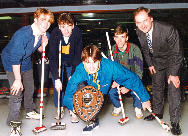 1991: Scott Johnson, 16, prepares to deliver the shield to the Robert Gordon’s College team which won the schools  curling tournament at Stoneywood. With him, from left, are Paul Preacher, 18, David Maxwell, 18, Graeme Chandler, 17, and Mr Wood.