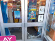 The door of the newsagents was smashed.