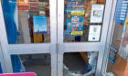 The door of the newsagents was smashed.