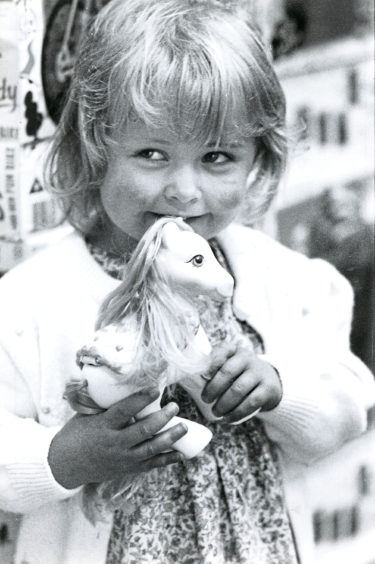 Aberdeen’s Kyla Higgs, 2, happily clutches her new favourite toy, My Little Pony