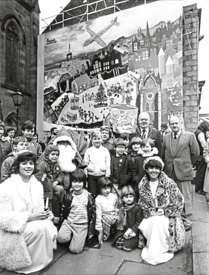 1984: Children gather round Santa at the official opening of the giant advent calendar at Langstane Kirk
