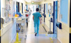 A nurse walks along a corridor at Aberdeen Royal Infirmary. Image: Kenny Elrick/DC Thomson