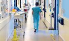 A nurse walks along a corridor at Aberdeen Royal Infirmary. Image: Kenny Elrick/DC Thomson