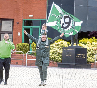 Celtic fans celebrate being awarded the Premiership title outside Parkhead yesterday.