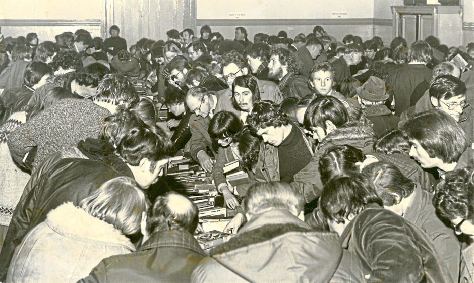1979: Crowds of people mob the counters in the Music Hall during the book-selling bonanza.