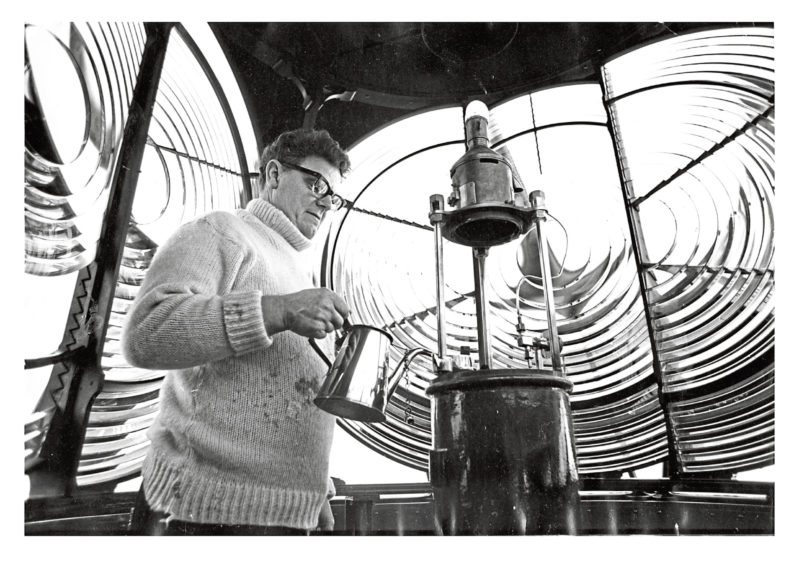 1978: Jack MacLean, tops up Rattray Head's paraffin-fuelled lamp. All around him are the ground glass lenses and reflectors which magnify and direct the beams from the light. A clockwork mechanism, installed when the lighthouse was built over 80 years ago, revolves the entire apparatus to produce the flashing effect. And, in clear weather, the lighthouse can be seen about 20 miles out to sea.
