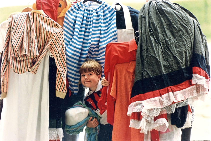 1994: Ross Ritchie peers through a mountain of costumes from the Texaco Theatre Summer School, which is appealing for rails to hang the clothes.