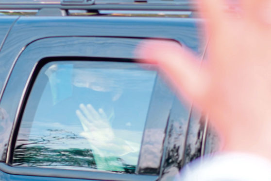 Donald Trump, still infectious with coronavirus, gets in a car with staff to wave at the crowd