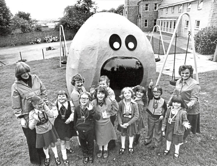 1978: A treat for the children of Linksfield School for the Deaf, Aberdeen, as they meet an enormous papier-mâché model of Dougal, the canine character from TV's "The Magic Roundabout," with assistant matron Mrs Marion Shearer and Mrs Hazel Andrews (left).