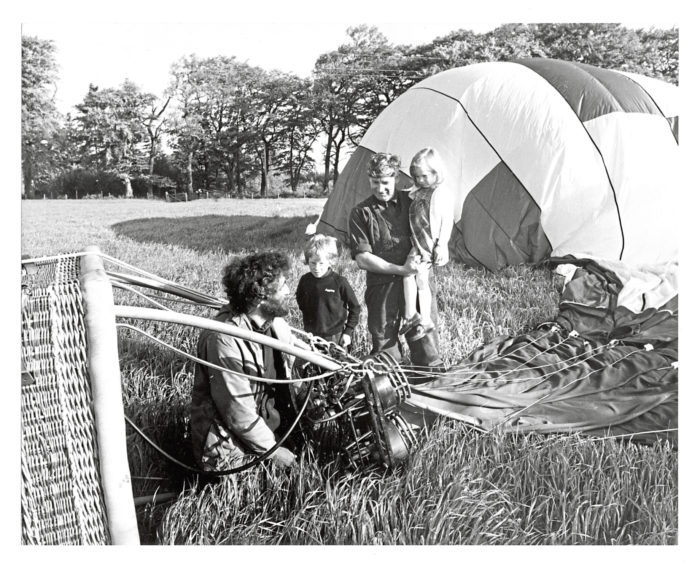 1981: Wide-eyed in amazement at the balloon which landed at the bottom of their garden - young Stuart Christie, his sister Emily, and famer Charles Duncan on the Drum Estate.