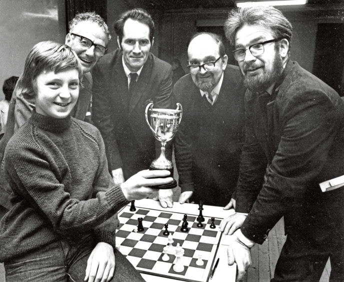 1978: Members of the Bon-Accord Chess Club gather round to look at the "Evening Express" trophy they were awarded as winners of the North of Scotland Chess League.
The youngest member Simon Munro (12) holds up the trophy in front of (left to right) J. Brand, J. A. Stevenson, S. A. Vizy and R. Daniel.
This is the second year running that the Bon-Accord club has carried off the trophy as winners of the league.
The club meets on Wednesdays and Fridays at 7 p.m. at the Guide Headquarters in Albyn Place.