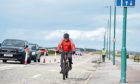A cyclist at Aberdeen beach