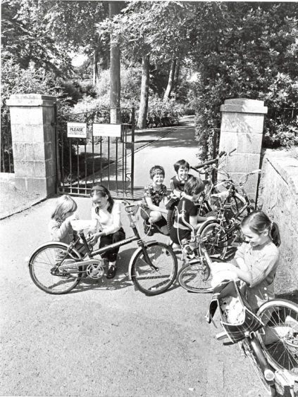 1981: A moment to lock up the bikes before these children get ready to enjoy the magic of the gardens.