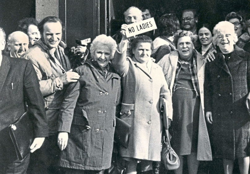 1973: Women protest in front of the Grill Bar, Aberdeen, on Union Street, trying to get access in the pub. The sign 'No Ladies' was snatched off the bar door and was passed triumphantly from one group of women to the other.