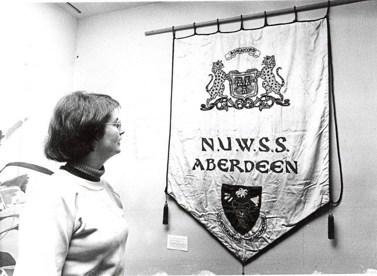 1982: Deborah Rolland, keeper of Museums at James Duns House, with the banner of the Aberdeen branch of the National Union of Women's Suffrage Societies from the early 1900s.