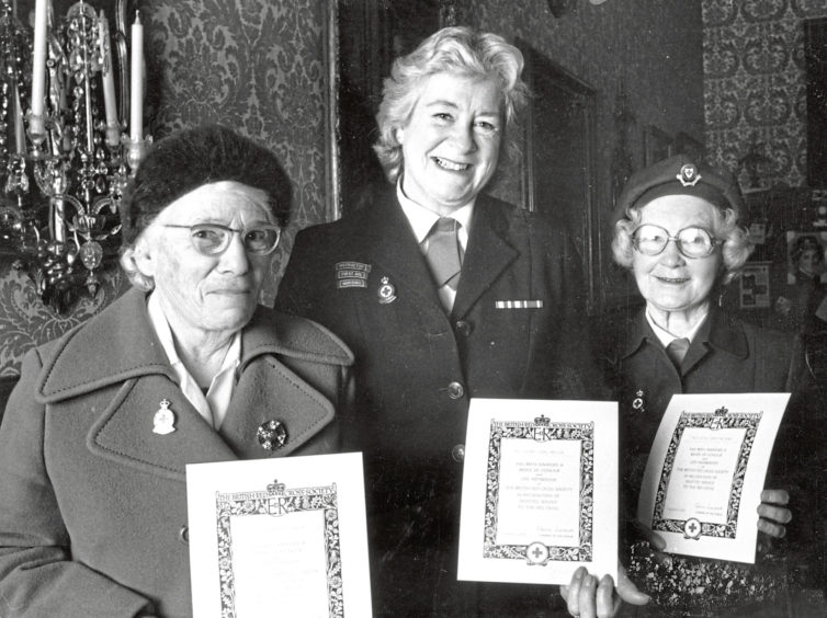 1987: Many years of devoted service to the Red Cross have been marked for three North-east women with the award of badges of Honour. Here after the ceremony at the Town and County Hall, Aberdeen, the three show their awards. They are (from left): Miss Helen Duncan, Carnegie Crescent, Aberdeen; Mrs Yvonne Morison, Mountblairy, Alvah, and Miss Jessie Grant, Cairncry Crescent, Aberdeen. The badges were presented my Mrs Hope Readman, Chairman Scottish branch council of the British Red Cross.