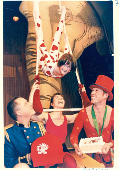 1994: Scotland's youngest trapeze artiste Wendy Ross, celebrates her 13th birthday rehearsing for the Lyric Musical Society production of Barnum at His Majesty's Theatre. Presenting her with a cake and sweatshirt are (from left): Tom Thumb (George R Mitchell), Scaramouche (Nicki McCretton), and Ring Master (Barry Cameron).