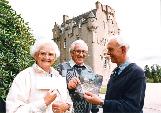 1991: Lucky 100,000ths visitors to Crathes Castle, Robert McMillan and his wife Peggy receive membership of the National Trust for Scotland from Jeffrey Boughey (right), administrator at the castle.