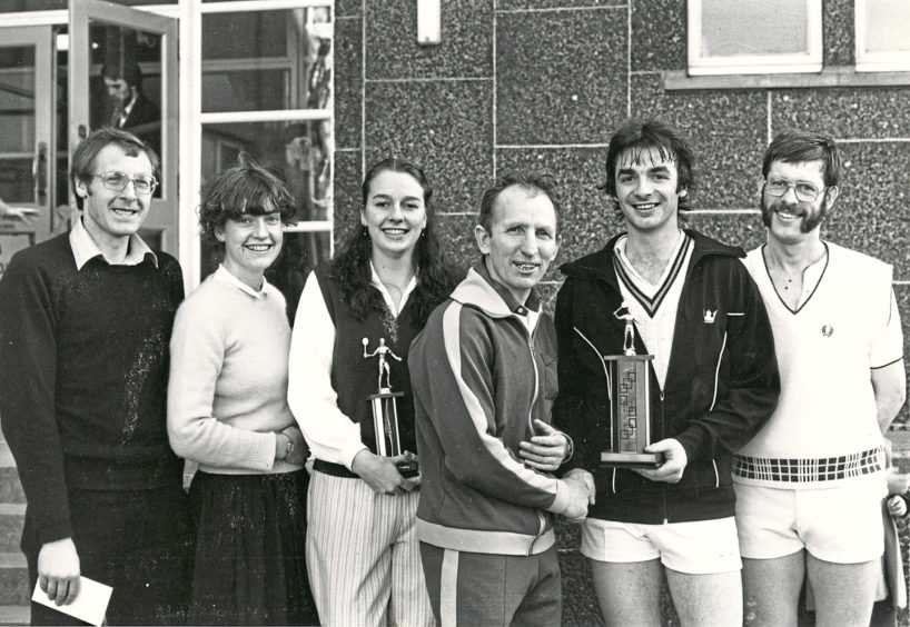 1982: Prizewinners at the Butchart tournament (left to right) - Sue Robertson (women's runner-up), Gail Wiggins (women's champion), Eric Farr (organiser), Sandy Adam (men's champion) and Mike Moore (runner-up).