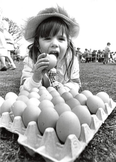 1987 - Three-year-old Melanie Gray, 172 Newburgh Circle, Bridge of Don, would rather eat her hard-boiled egg than roll it.
She was taking part in a special Easter holiday Eggstra attraction for children organised by Aberdeens leisure and recreation department at Duthie Park yesterday.
Sporting their best Easter bonnets, hundreds of children decorated the eggs and rolled them down the park slope.
The council also laid on to inflatable play castle for the children. More than 500 eggs, donated by Homestead Eggs, were specially boiled for the occasion.