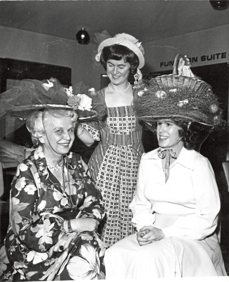 1978 - A heady experience for three members of the Petroleum Womens Club of Scotland as they show off their Easter bonnet creations during their get-together at the Westhill Inn. Left to right  treasurer Mrs Gerda Stamm, organiser Mrs Isobel Edwards and activities chairman Mrs Brenda Artopeous.