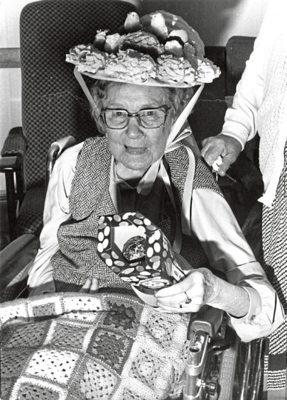 1988 - Here is my prize  Miss Elsie Michie has a treat in store  her newly-won Easter egg  after taking first prize in the Easter bonnet parade at Hillside House Nursing Home, Banchory.