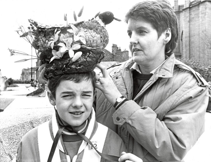 1988 - Inverness youngster Ruairidh Nicolson gets some last-minute adjustments to his millinery creation from mum, Brenda, before the Easter bonnet parade, part of the Scottish Connection festivities, held in the St Nicholas Centre, Aberdeen, on Saturday.