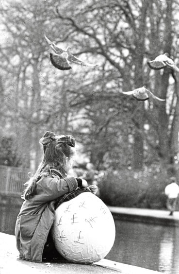 1989 - ‘Nice day for the birds… and Easter. Jenny Milne (7), Milltimber, was doing her good deed for Easter by carrying a huge Easter egg advertising ‘’Fresh Air’’ the students’ show in HM Theatre. But little girls get tired and feeding the pigeons in the Duthie Park is also a nice way to spend an Easter Day.’