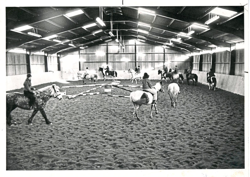1969: The new indoor riding school of the Hayfield Centre at Hazlehead, Aberdeen, which the public are invited to visit next Saturday. Below is Miss Morven Will on Manolito who can unbolt his loosebox door.