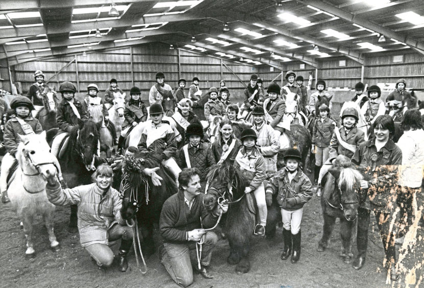 1986: Young riders and their mounts enjoying the Pony Club party at Hayfield Riding School, Aberdeen.