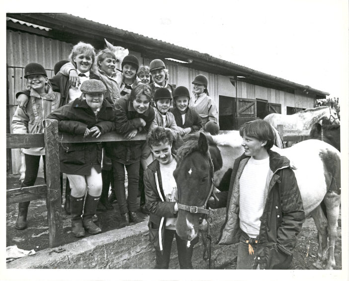 1986: Studying their mounts are these youngsters who took part in the hunter trial competition at Hayfield Riding School, Aberdeen, on Saturday.