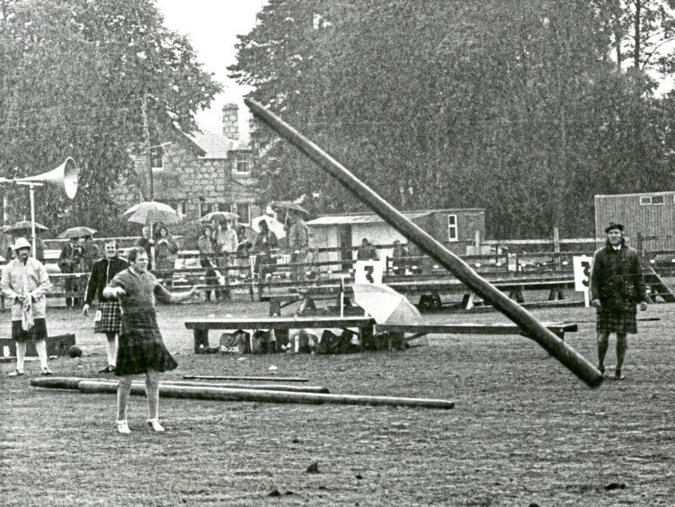 1979 - Spectators braved the rain as a drenched Neil Fyvie competes in the caber tossing event at the Aboyne Games