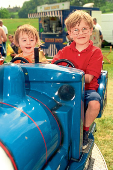 1996 - Having fun on one of the rides at the Stonehaven Games are Fergus Robertson, 5, and his sister Grace, 2