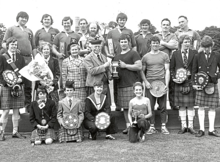 1980 - Chieftain of the Stonehaven Highland Games, the Earl of Kintore, presents the trophy to the heavy champion, George Donaldson, of Forfar