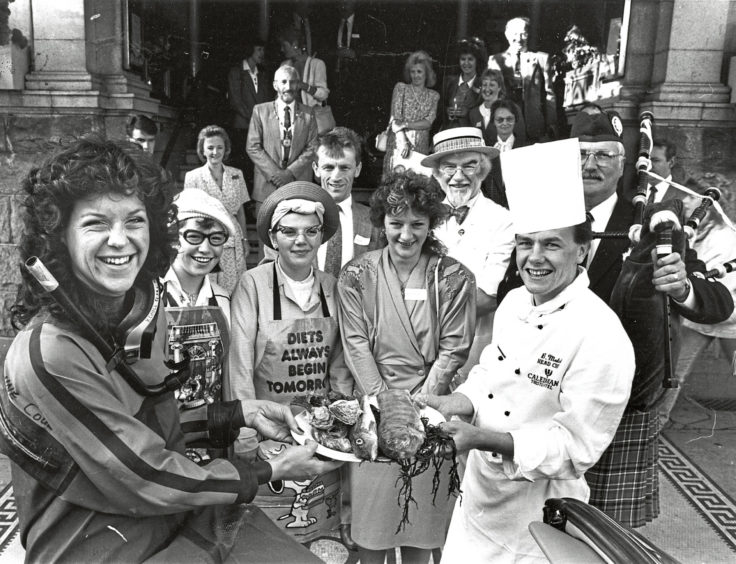 1989 - ‘Deep sea diver’ Geo Mitchell hands over the fish  for the breakfast to launch the Aberdeen Fish Festival  Week at the Caledonian Hotel, Aberdeen, to head chef  Brian Mutch