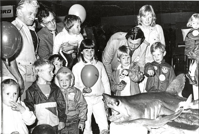 1985 - Some of the children at the festival are intrigued by ‘Jaws’  as they sample shark and swordfish dishes at fishmonger  Ken Watmough’s stand
