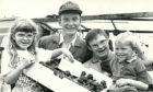 1992 - A barbecue and barn dance held by  Strichen farmer Gammack Coutts and his  wife, Moira, raised £1,121 for Easter  Anguston Farm where their son, Russell,  19, is a trainee. David Walker, second  left, and Russell accept the cheque from  Russell’s siblings Claire and Clark