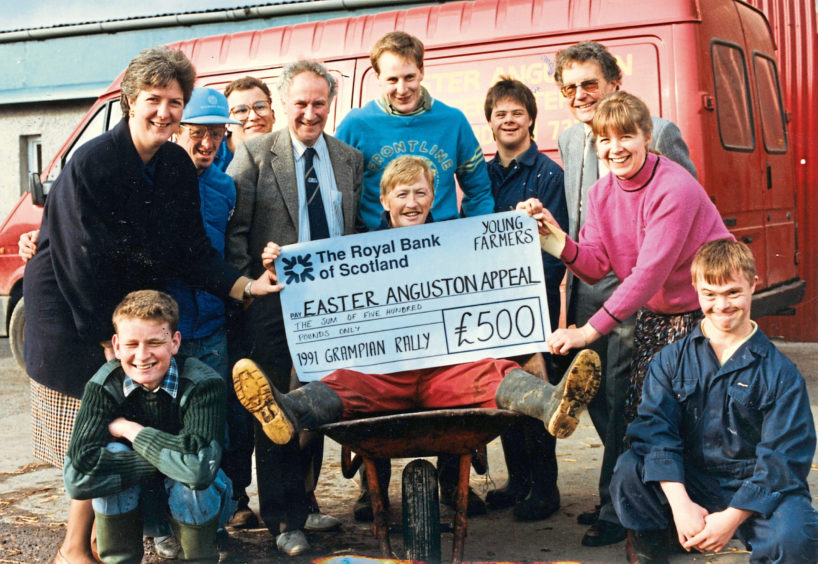 1991 - Entertainer Robbie Shepherd, centre left, helps  present a £500 cheque from Grampian Young Farmers